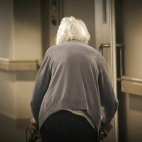 Elderly walking towards light