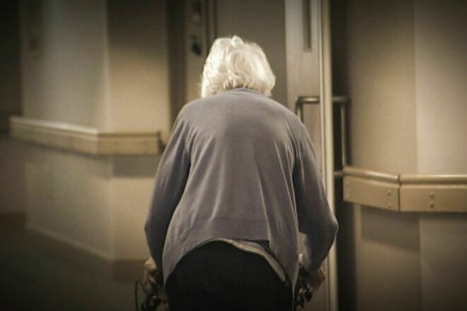 Elderly walking towards light